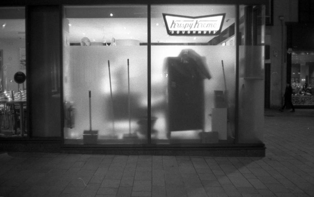 Cleaning equipment in the frosted window of Krispy Kreme Doughnuts 