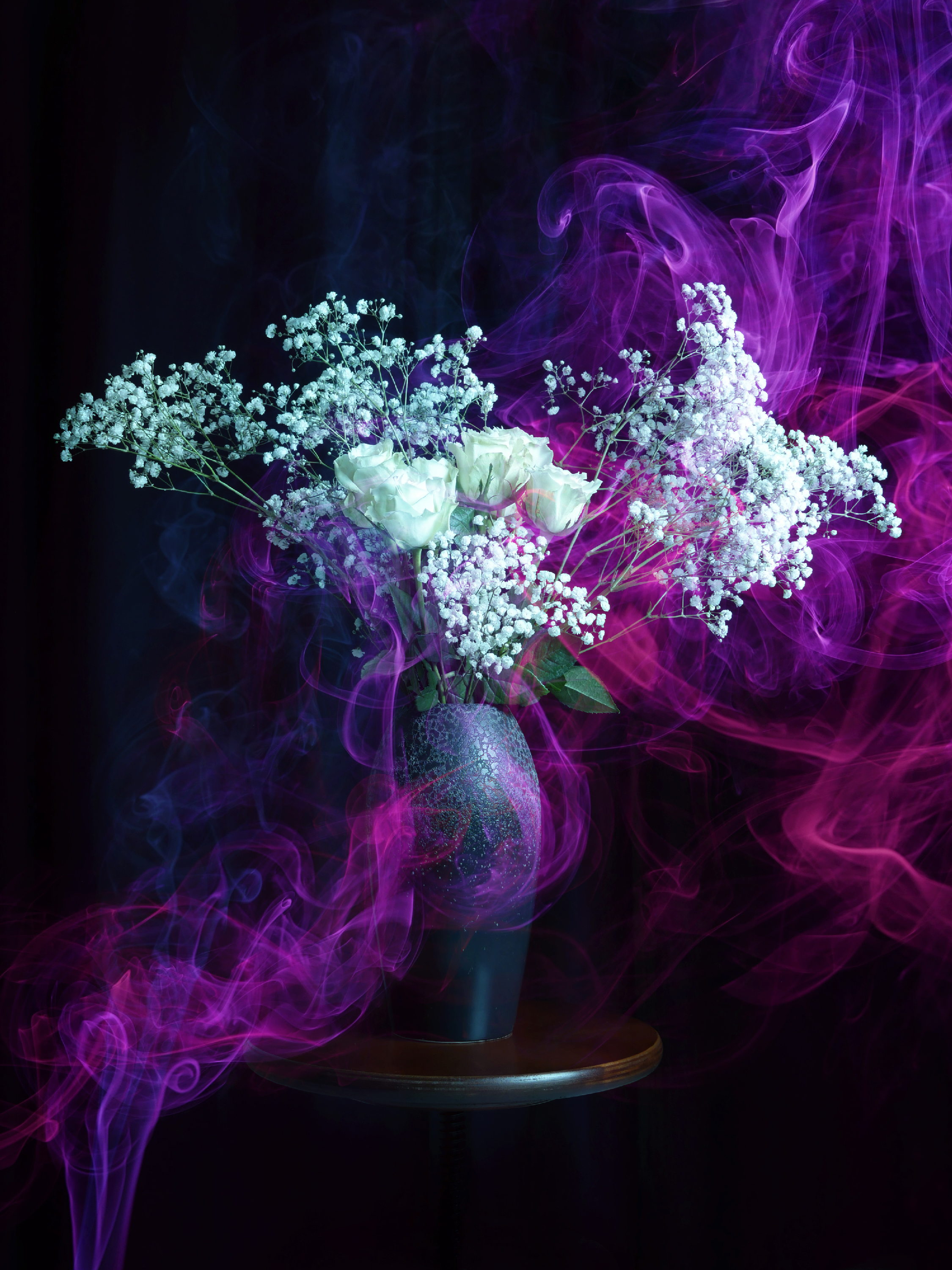 white roses with coloured gel smoke